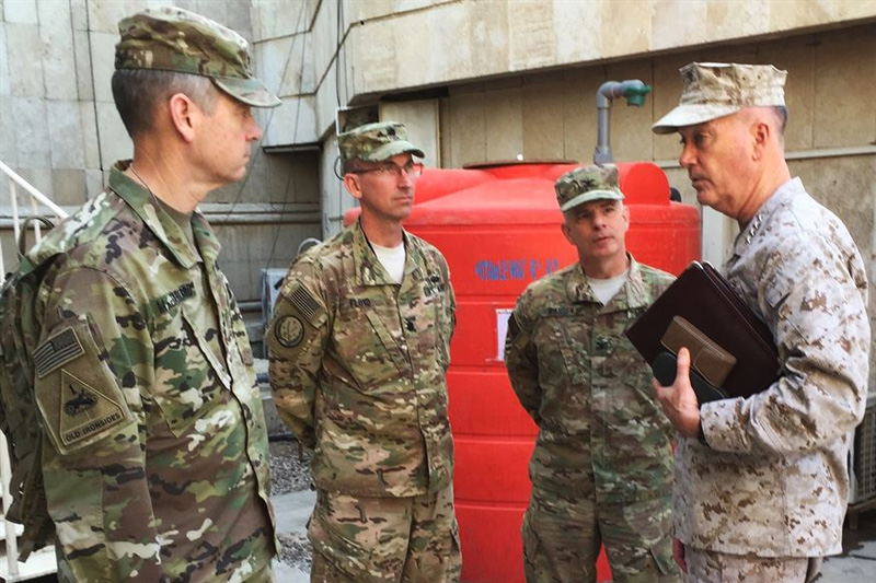 Marine Corps Gen. Joe Dunford, chairman of the Joint Chiefs of Staff, speaks with Army Col. Steve Warren, second from right