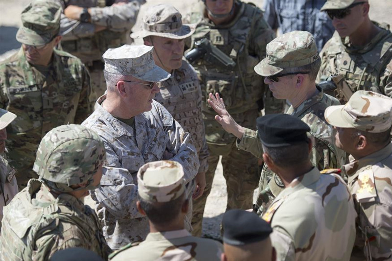 Marine Corps Gen. Joe Dunford, center left, chairman of the Joint Chiefs of Staff, speaks with Army Lt. Gen. Sean MacFarland, commander of Combined Joint Task Force Operation Inherent Resolve