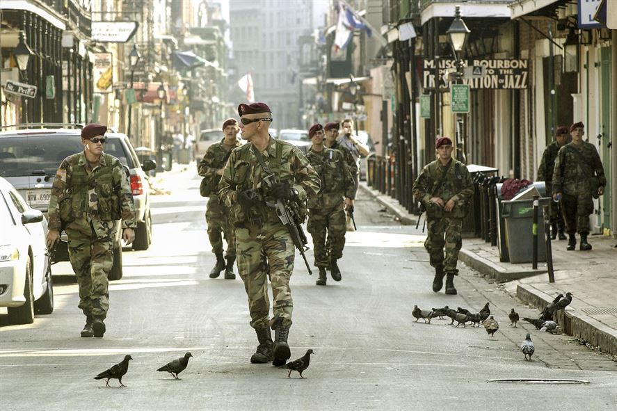 Soldiers patrol nearly deserted streets in the French Quarter i