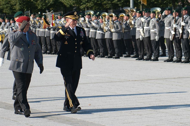Army Gen. Martin E. Dempsey, chairman of the Joint Chiefs of Staff, and German Army Gen. Volker Wieker, chief of defense, salute during a pass-and-review ceremony of the German honor guard at the Ministry of Defense in Berlin.