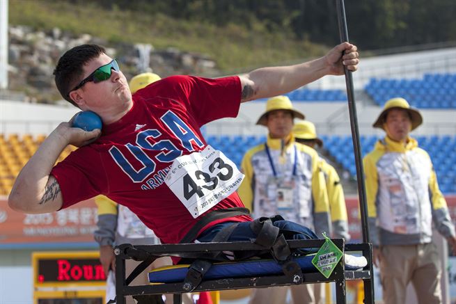 Disabled U.S. Athlete competing in CSIM Military World Games throws a shotput.