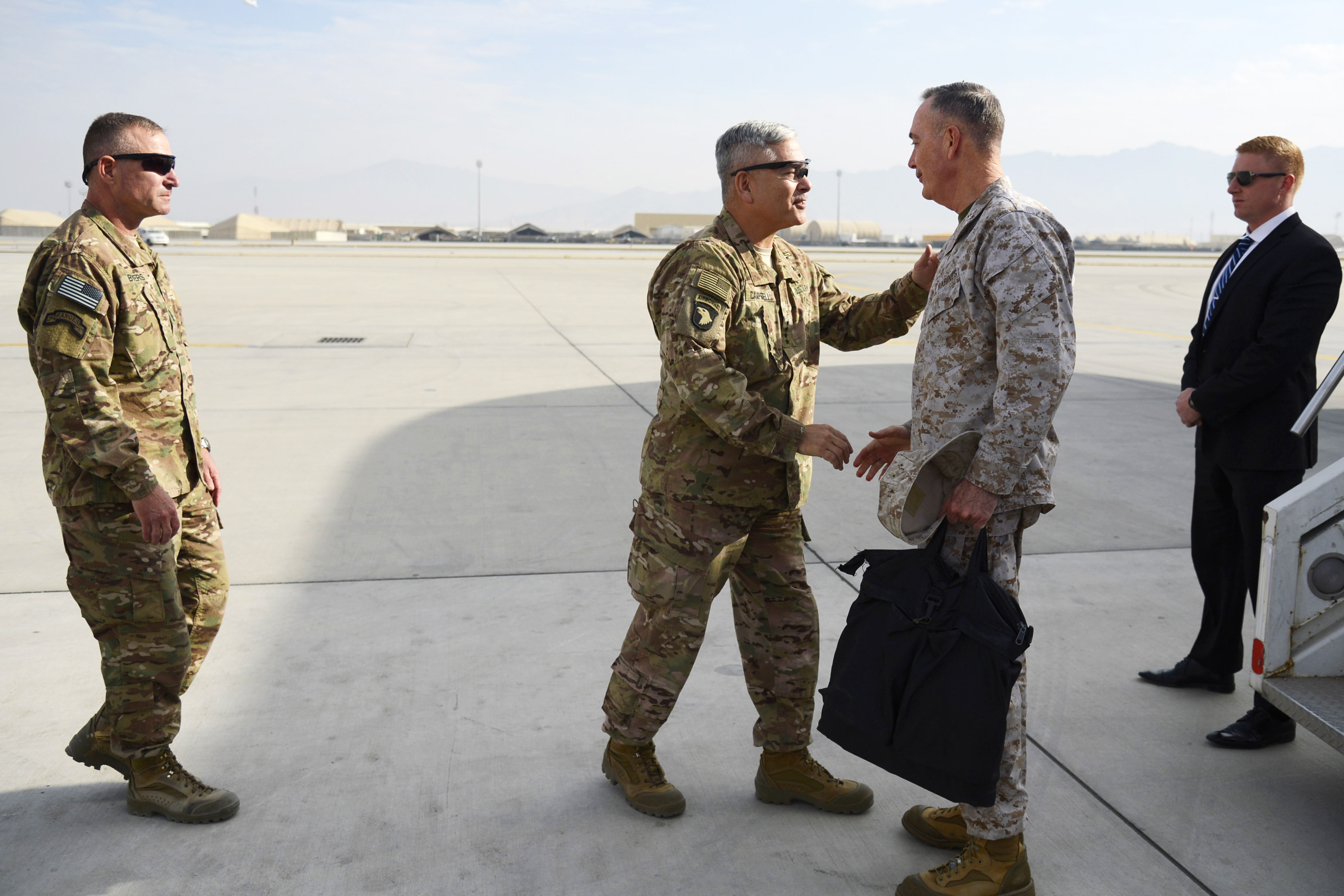 U.S. Army Gen. John Campbell shaking hands with U.S. Marine Corps Gen. Joseph F. Dunford Jr., chairman of the Joint Chiefs of Staff, on the tarmac