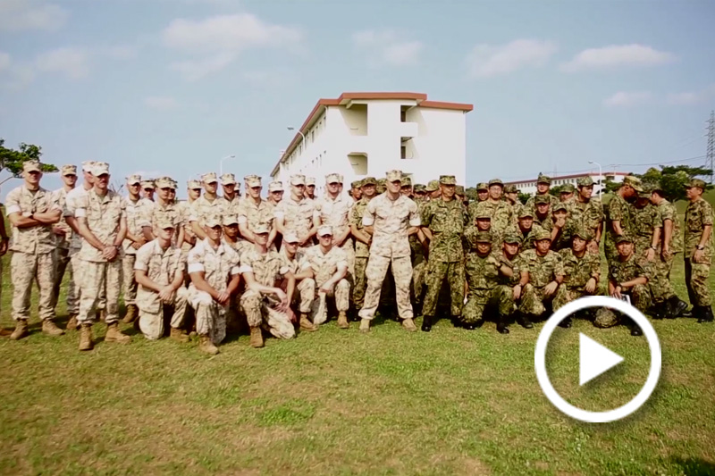 Screen grab of soldiers standing for a group photo.