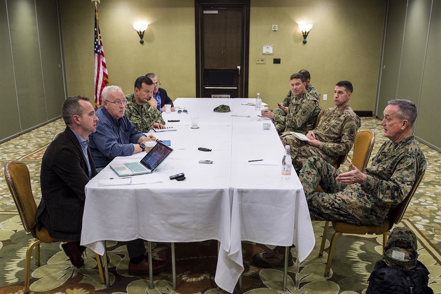 Marine Corps Gen. Joseph F. Dunford Jr., chairman of the Joint Chiefs of Staff, right, meets with reporters