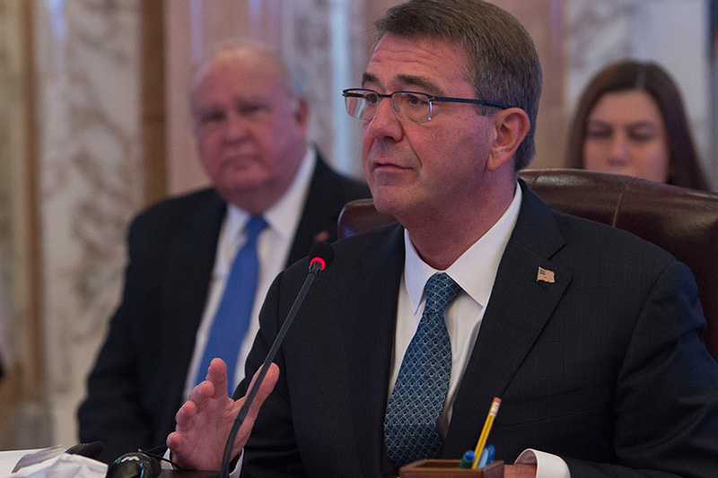 Defense Secretary Ash Carter delivers remarks into a microphone.