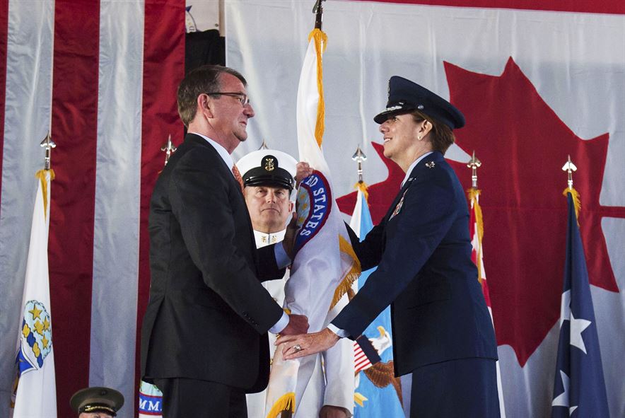 Defense Secretary Ash Carter hands the U.S. Northern Command flag to Air Force Gen. Lori J. Robinson