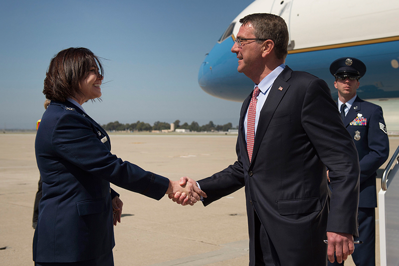 Defense Secretary Ash Carter shaking hands with Air Force Col. Rosemary M. Smith, commander of the 129th Maintenance Group.
