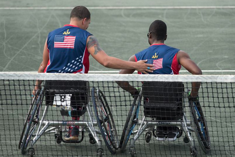 Army veteran R.J. Anderson, right, and Navy veteran Javier Rodriguez leave the court after playing the New Zealand team in the wheelchair tennis semifinals