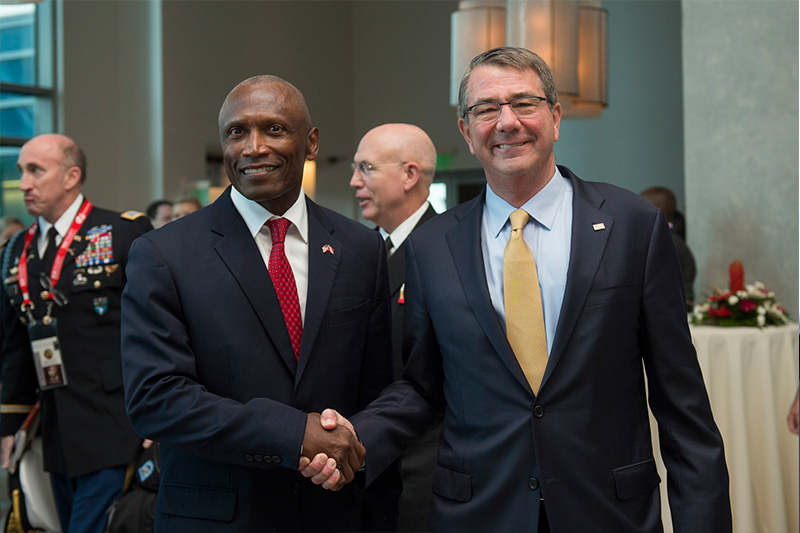 Secretary of Defense Ash Carter greets U.S. Ambassador to Trinidad and Tobago John Estrada