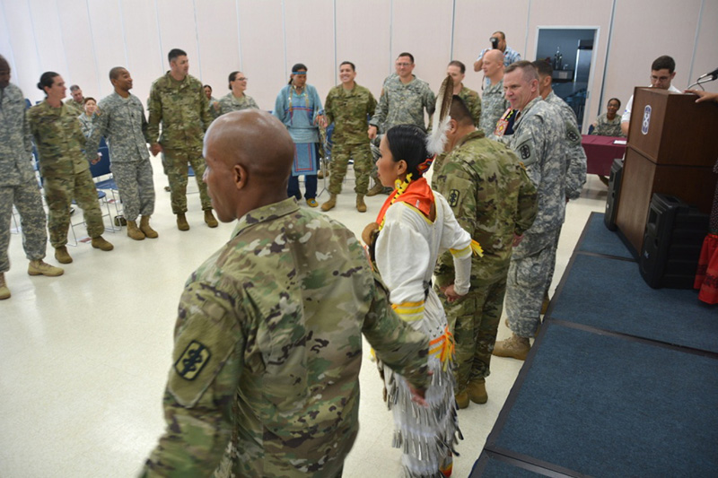 Members of 18th Medical Command (Deployment Support) participate in a traditional round dance.