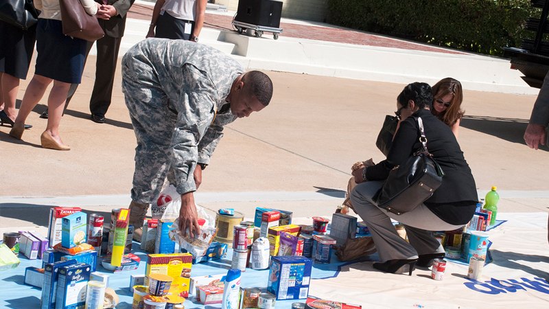 A service member places a food item on the map