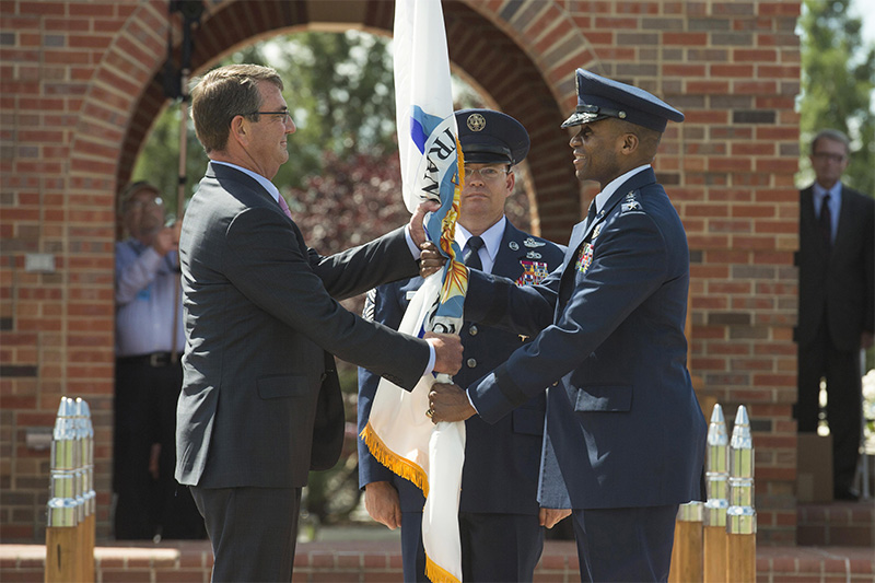 Defense Secretary Ash Carter handing the U.S. Transportation Command flag to Air Force Gen. Darren W. McDew.