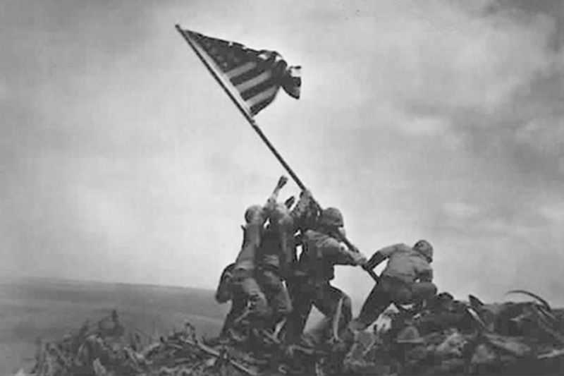 U.S. Marine Corps Pfc. Ira Hayes, left, a Pima from Arizona, helped four fellow Marines and a Navy corpsman raise the second flag on Mount Suribachi, Japan.