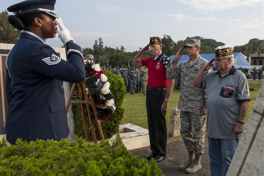 Veterans saluting a wreath