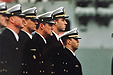 Uniformed Marines stand in a line.