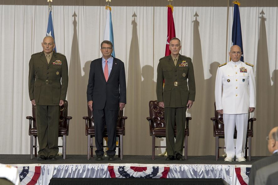 U.S. Marine Corps Gen. Joseph F. Dunford, chairman of the Joint Chiefs of Staff, Defense Secretary Ash Carter, U.S. Marine Corps General John F. Kelly and U.S. Navy Admiral Kurt W. Tidd stand at attention during the during the change of command ceremony at U.S. Southern Command headquarters