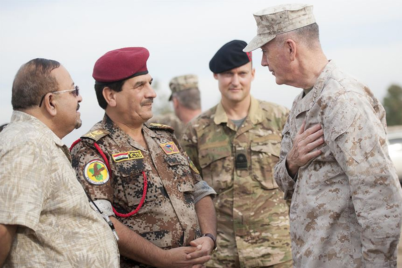 Photo of U.S. Marine Corps Gen. Joseph F. Dunford Jr., right, chairman of the Joint Chiefs of Staff, meeting with a member of the Iraqi special operation forces at Area VI training site in Baghdad.
