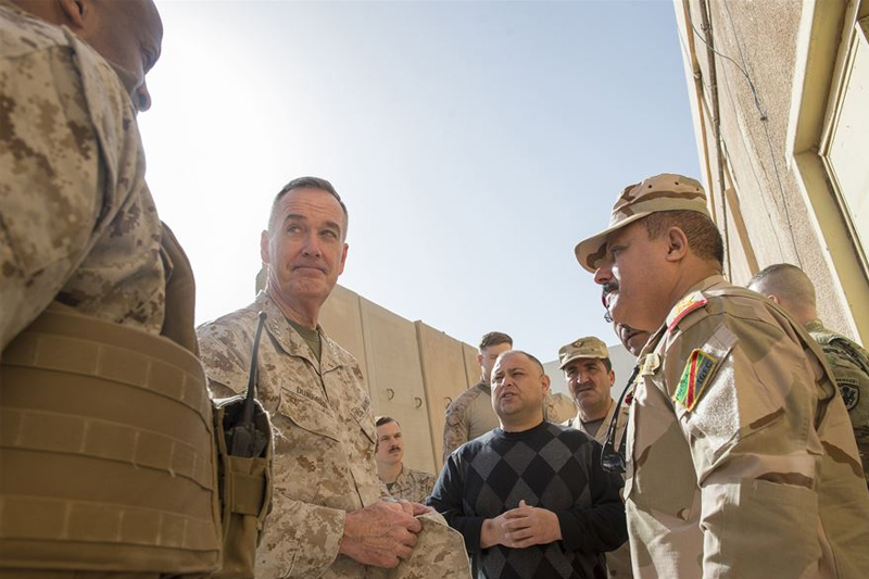 Photo of U.S. Marine Corps Gen. Joseph F. Dunford Jr., center left, chairman of the Joint Chiefs of Staff, listening to Marine Col. David Coconut, left, during a group discussion with Iraqi commanders.