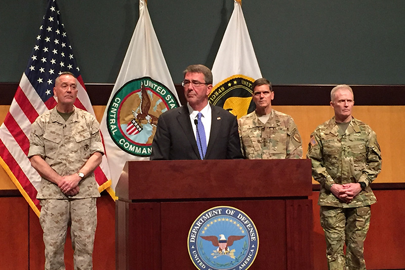 Photo of Defense Secretary Ash Carter, Marine Corps Gen. Joe Dunford, chairman of the Joint Chiefs of Staff, Army Gen. Joe Votel, commander of U.S. Central Command, and Army Gen. Raymond A. 'Tony' Thomas, commander of U.S. Special Operations Command, standing behind a podium.