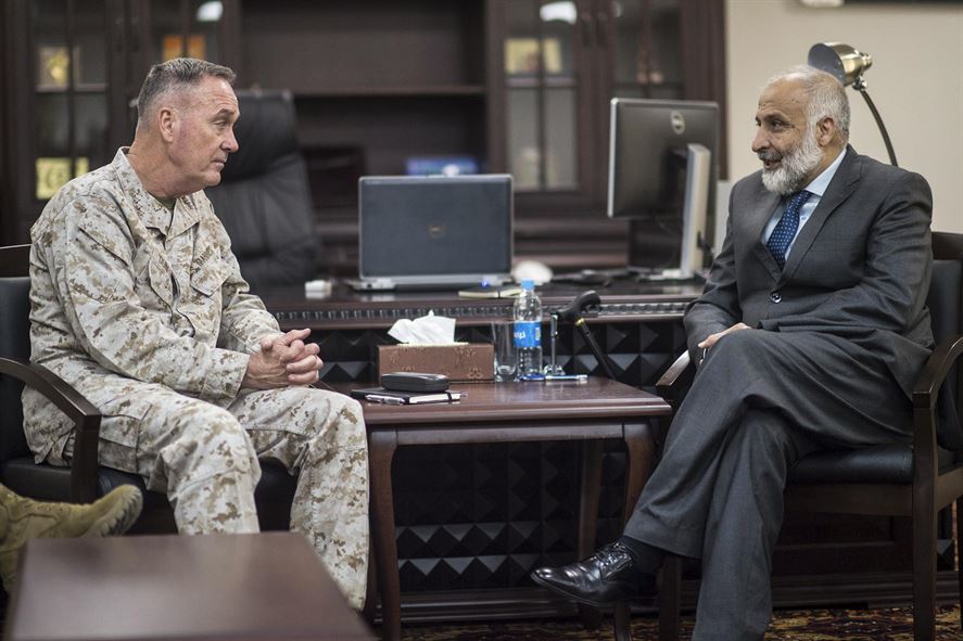 Marine Corps Gen. Joseph F. Dunford Jr., chairman of the Joint Chiefs of Staff, and Afghan Defense Minister Masoom Stanekzai sitting across from each other talking.