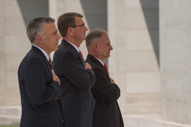 Defense Secretary Ash Carter, center, U.S. Ambassador to the Philippines Philip S. Goldberg, left, and a cemetery official rendering honors.