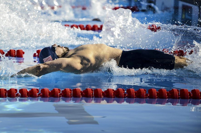 A U.S. team swimmer propels himself from the start platfor