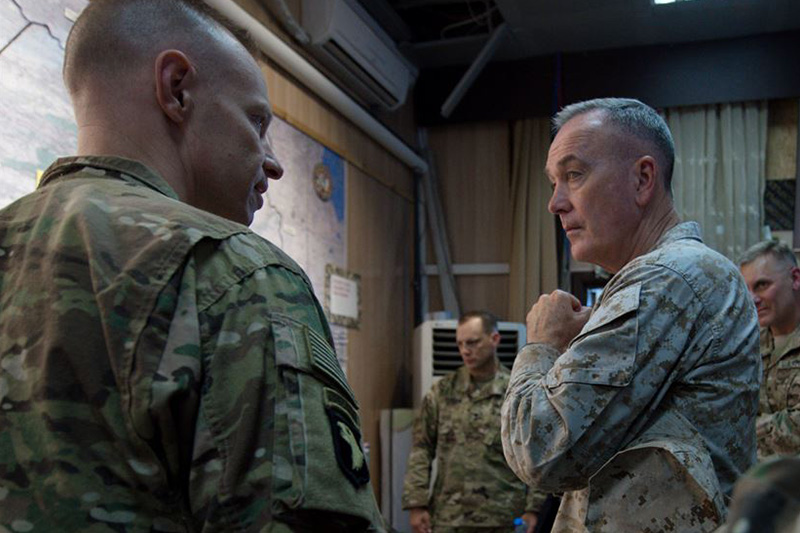 Marine Corps Gen. Joe Dunford, chairman of the Joint Chiefs of Staff, receives a campaign update from a U.S. service member near Irbil.