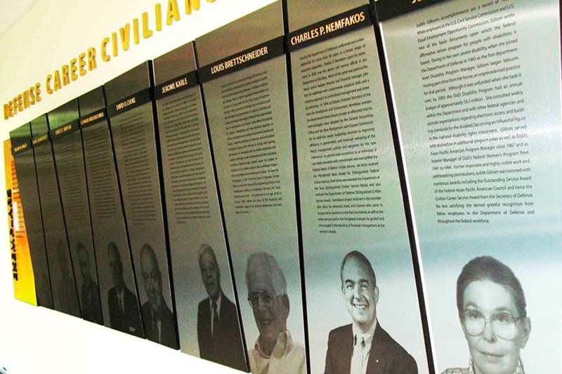 Judith C. Gilliom's photo and story are featured along with those of several other distinguished Defense Department civilian employees at a wall-mounted display