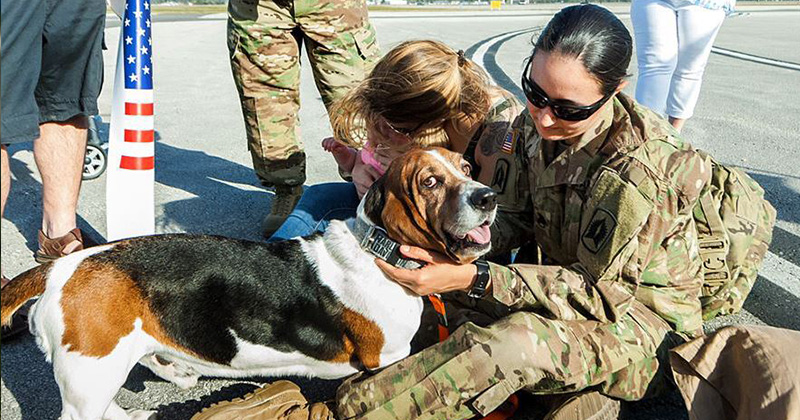A Florida National Guard soldier greets her dog and family members in Daytona Beach, Fla., March 10, 2016, following a deployment to Afghanistan.