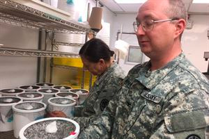 Army Col. Paul Keiser holds one of the insectary’s mosquito habitats