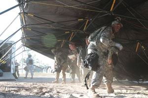 Soldiers and airmen set up a headquarters tent.